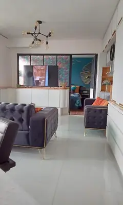 a living room with a couch and a tv at Liège centre Médiacité appartement possible parking terrasse immense 8ème pour 2 personnes in Liège