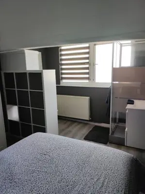 a bedroom with a bed and a window at Escale in Liège