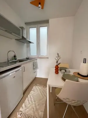 a kitchen with a table and chairs in a room at St Catherine in Liège