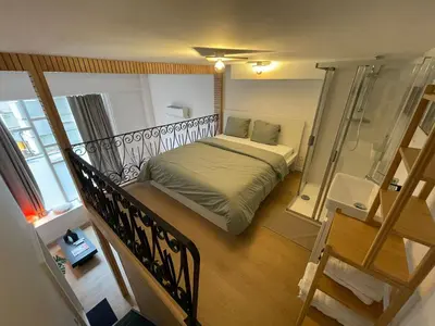 a small bedroom with a bed and a balcony at St Catherine in Liège