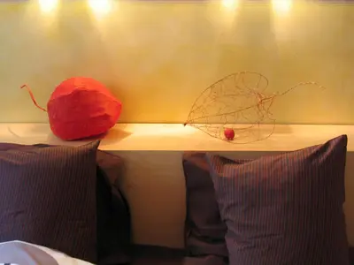 a shelf with two pillows and a leaf on it at B&B Matin Tranquille in Liège