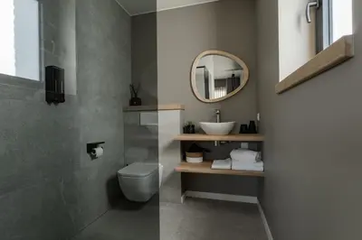 a bathroom with a sink and a toilet and a mirror at Luxury house 