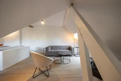 a living room with a couch and a chair at Het Generaaltje in Hasselt