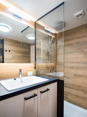 a bathroom with a sink and a glass shower at Welldone Resort - Cozy Saxofoon in Nieuwerkerken