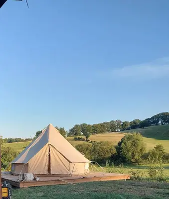 a large tan tent sitting in a field at Le Bunker du Houyeux in Herve