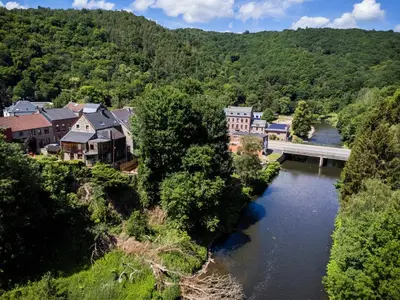 a town with a bridge over a river at Côté cour, côté source chambre d'hôtes in Chaudfontaine