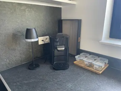 a room with a lamp and a table with glass jars at Casa 47 in Eupen