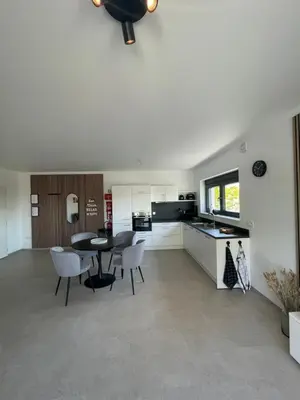 a kitchen and dining room with a table and chairs at Casa 47 in Eupen