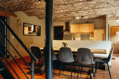a dining room with a table and chairs at L'Orée du Bois by WelcHome in Verviers