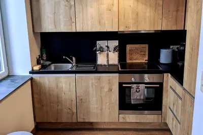 a kitchen with a sink and a stove at Liège City by WelcHome in Liège