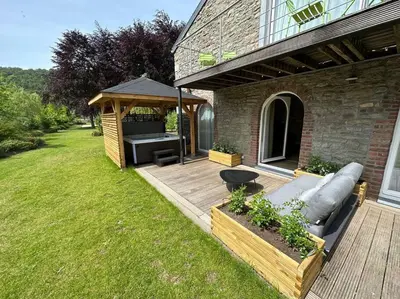 a backyard with a couch and a gazebo at Jacuzzi - Sauna - BBq - Jardin - Garden Lodge - Myosotis in Olne