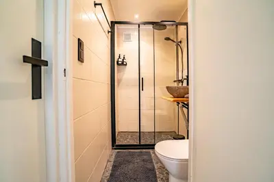 a bathroom with a shower and a toilet at Boshuisje Rekem - Topo in Lanaken