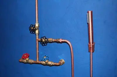 a blue wall with a pipe and a toothbrush at De Tuinkamer in Lanaken