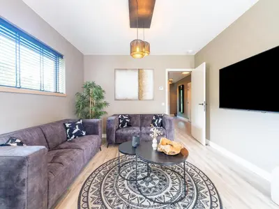 a living room with a couch and a table at Beaunita Luxe Stay in Hamont in Hamont-Achel