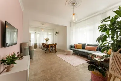 a living room with a couch and a table at Vakantiewoning 't Hovenshuis in Kinrooi