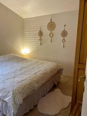 a bedroom with a bed and some decorations on the wall at Chalet Sint-Hubertus Du Bois in Zutendaal