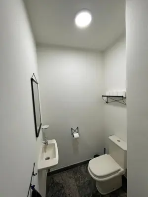 a white bathroom with a toilet and a sink at Vakantiewoning Villa 35 in Maasmechelen