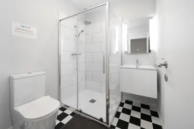 a bathroom with a shower and a toilet and a sink at Maison 4 chambres avec jardin in Liège