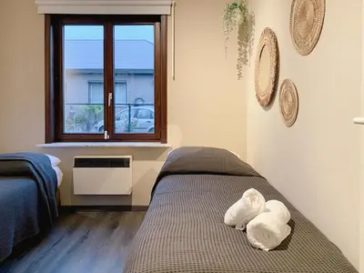 a bedroom with a bed with towels on it at 8P 4B Beautiful Villa with swimming pool in Zonhoven in Genk