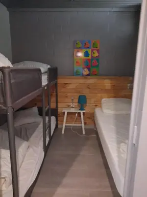 a dorm room with two bunk beds and a table at Hengelhoef Berk 5 in Houthalen-Helchteren