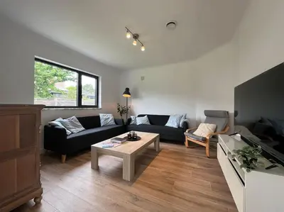 a living room with a couch and a table at Boldermountain Guesthouse in Heusden - Zolder
