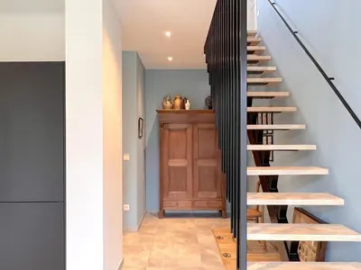 a staircase in a house with black railings at Achter de Hegge in Riemst