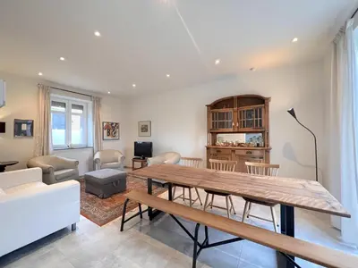 a living room with a wooden table and chairs at Woonhuys in Riemst