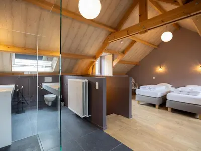 a room with two beds and a glass wall at t Bakhuys in Riemst