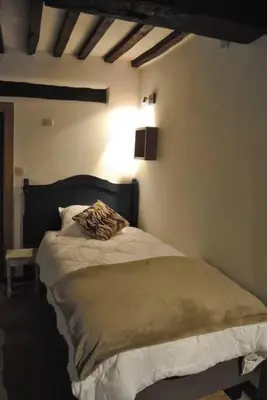 a bedroom with a bed in a room at Le Chat Roi - Charneux in Herve
