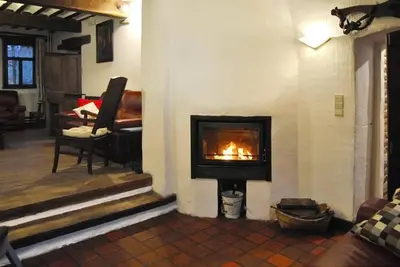 a fireplace in a living room with a fire place at Le Chat Roi - Charneux in Herve