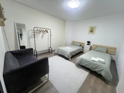 a living room with two beds and a couch at Appartement Verviers in Verviers
