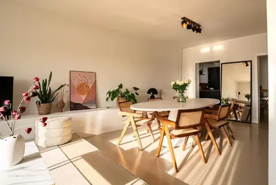 a living room with a table and chairs at Maas Suites - The River House with private sauna in Lanaken