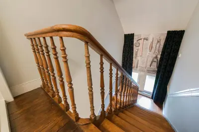 a wooden staircase in a home with a window at Boutique Hotel Huys van Steyns in Tongeren