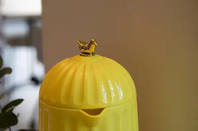a yellow container with a gold figurine on top of it at Luxe hoeve voor groepen tot 26 personen in Borgloon in Borgloon