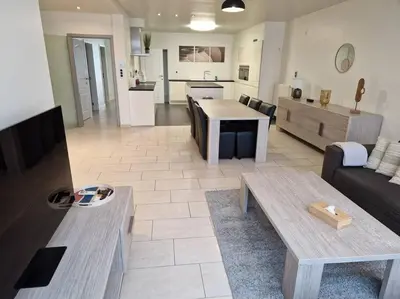 a living room with a couch and a table at Tuinappartement van 175m² en 4 slaapkamers in Hasselt