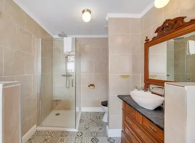 a bathroom with a shower and a sink and a toilet at Café René Borgloon in Borgloon