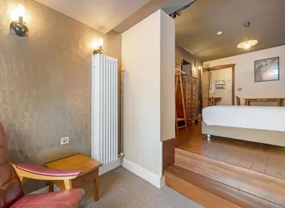 a living room with a bed and a couch at Café René Borgloon in Borgloon