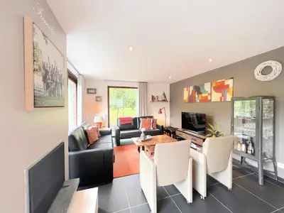 a living room with a couch and a table at De Lelie in Rekem