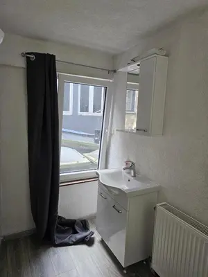 a bathroom with a sink and a window at Logment Outremeuse 1D in Liège