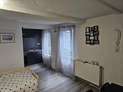 a living room with a couch and a window at Logment Outremeuse 1D in Liège