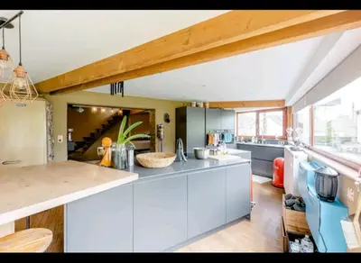 a kitchen with white cabinets and a counter top at Gee is Sharing her home in Liège