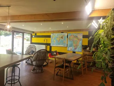 a dining room with a table and a map on the wall at Gee is Sharing her home in Liège
