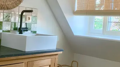 a kitchen with a sink and a window at Zolder appartement Le Grenier in Dilsen-Stokkem