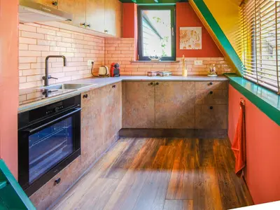 a kitchen with a sink and a stove at Boshuisje Pinus Sonnevijver Residences in Lanaken