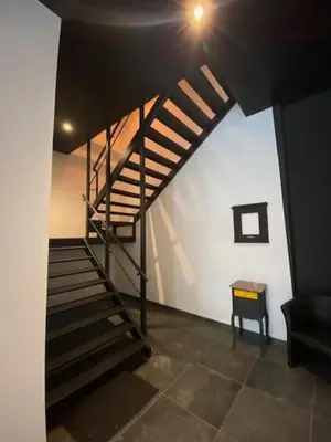 a staircase in a room with a stair case at Les Quais de la Vesdre in Verviers