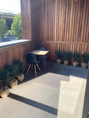 a patio with a table and chairs and a fence at Les Quais de la Vesdre in Verviers