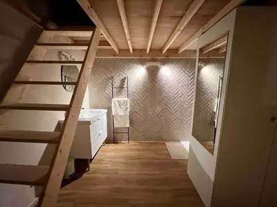a room with a staircase and a bathroom with a sink at Maison avec 4 suites & Rooftop en plein centre ville - Place Saint Paul in Liège