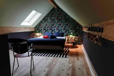a bedroom with a bed and a table and chairs at L’écrin vintage - Hors Château & Marches de Bueren in Liège
