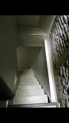 a stair case with white stairs in a building at Petite maison Liégeoise «la cabane de Liège» in Liège
