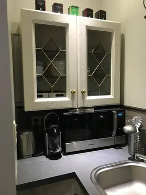 a kitchen with a sink and a microwave at Petite maison Liégeoise «la cabane de Liège» in Liège